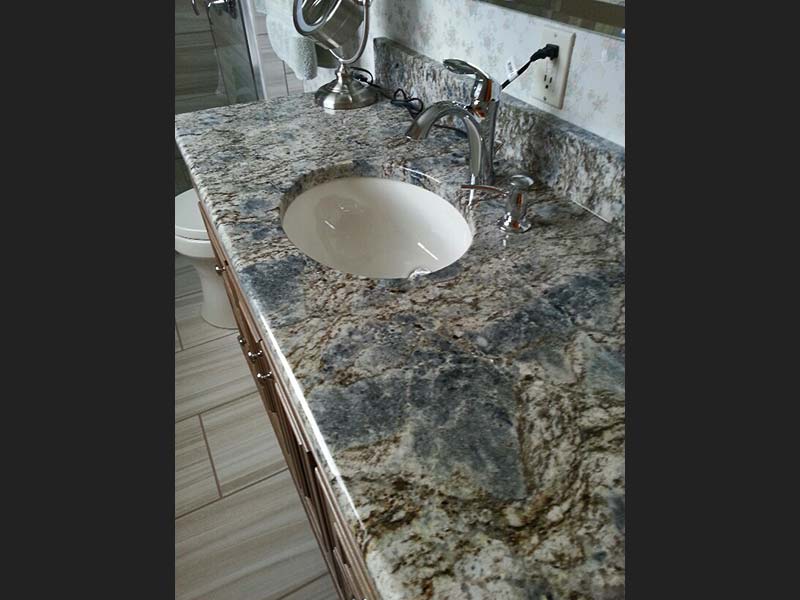 The length of this bathroom counter shows off Diamond Wave Granite&#39;s spectacular colors.