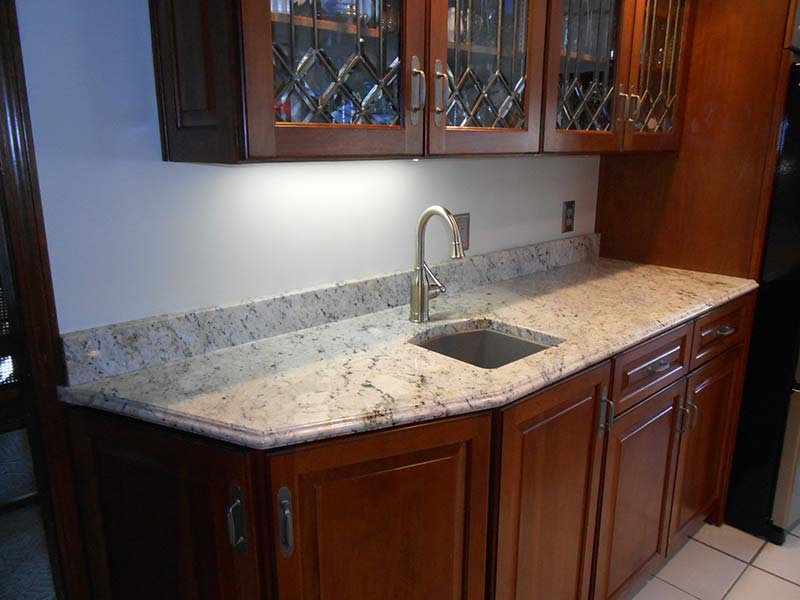 A Delicatus Granite counter takes center stage in this bar!