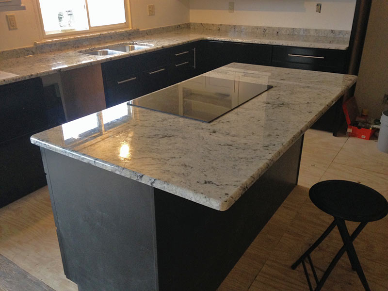 Colonial White Granite kitchen counter and island with Gray cabinets.